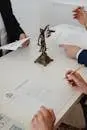 Three professionals reviewing divorce papers in a law office setting.